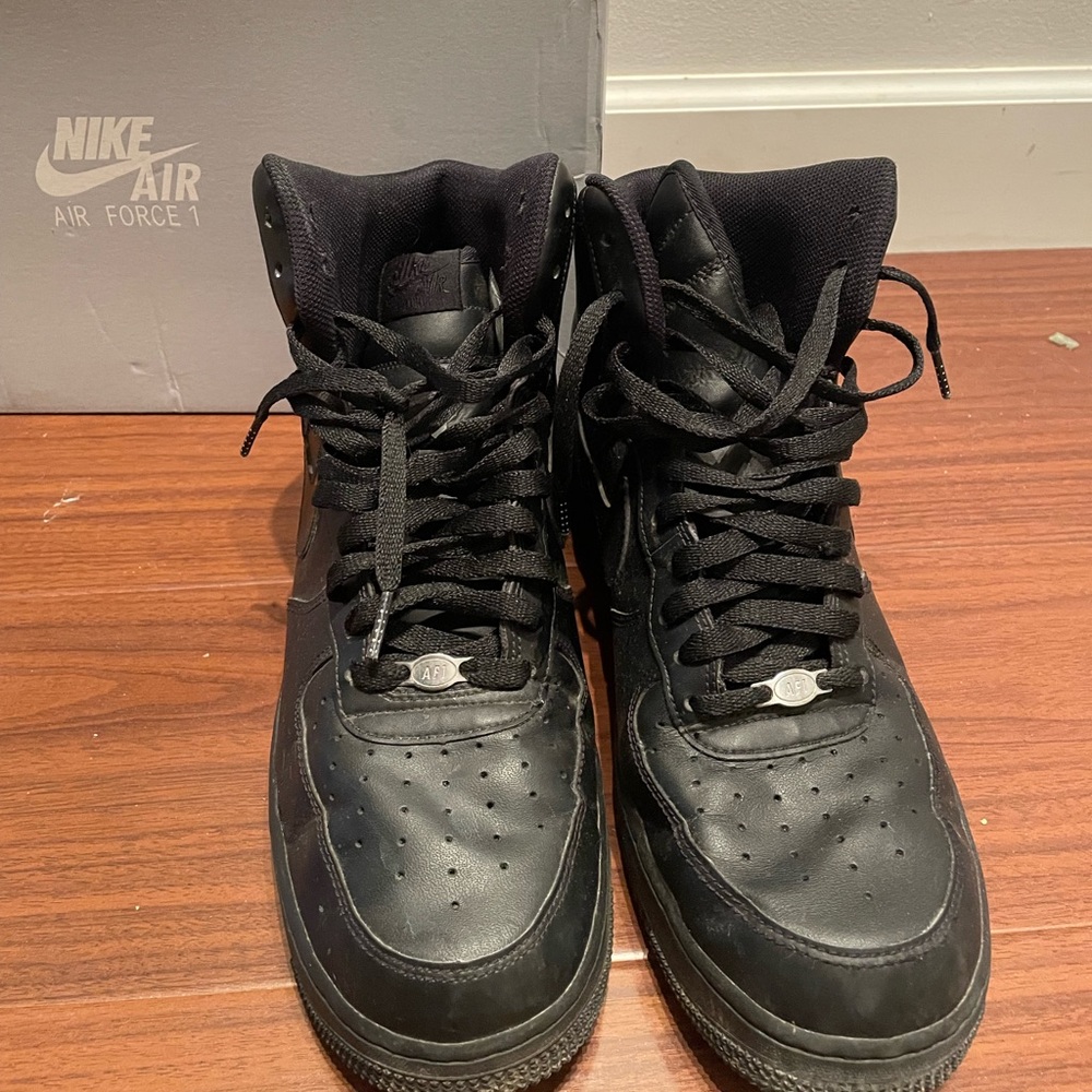 All black high top Nike Air Force ones.